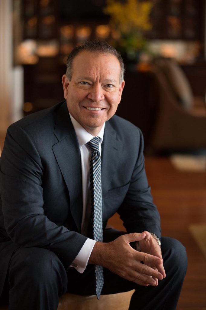 A corperat portrait by Business Photographer Nick Reid of a businessman sitting in a office looking friendly and approachable.